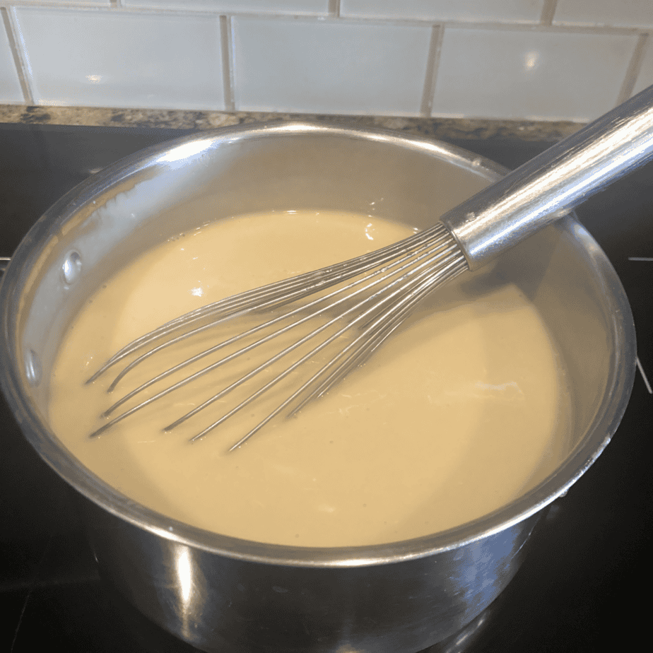 Whisking custard mixture with coconut milk and tapioca starch for homemade ice cream