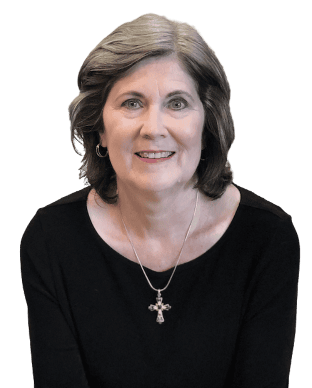 Terri Ward in a black top with a cross necklace and now background