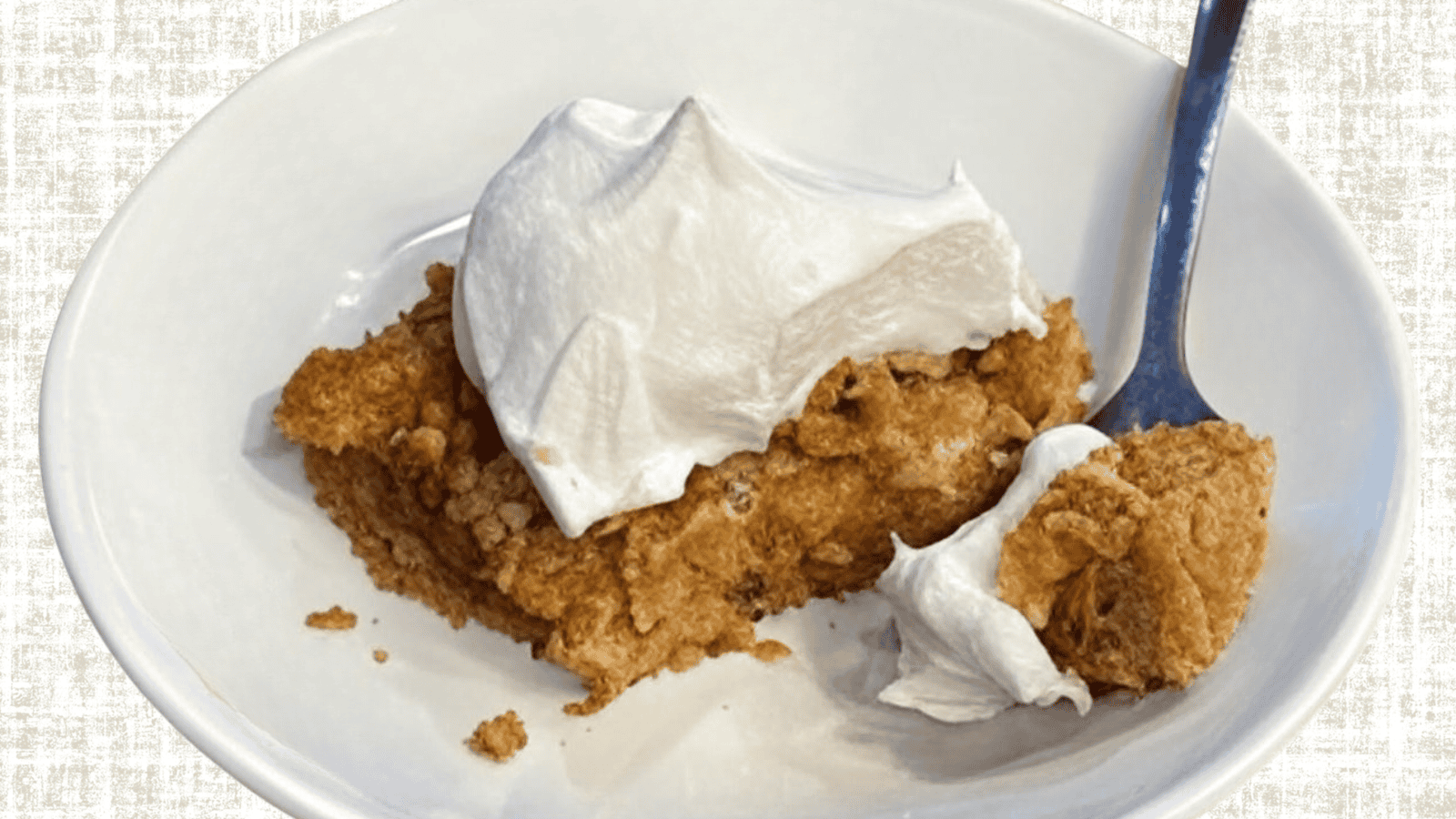 pumpkin-dessert-linen Gluten-free dairy-free pumpkin dessert with golden crumble topping and whipped coconut cream on white plate