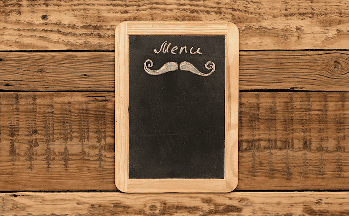 Blank chalkboard menu on a wooden background