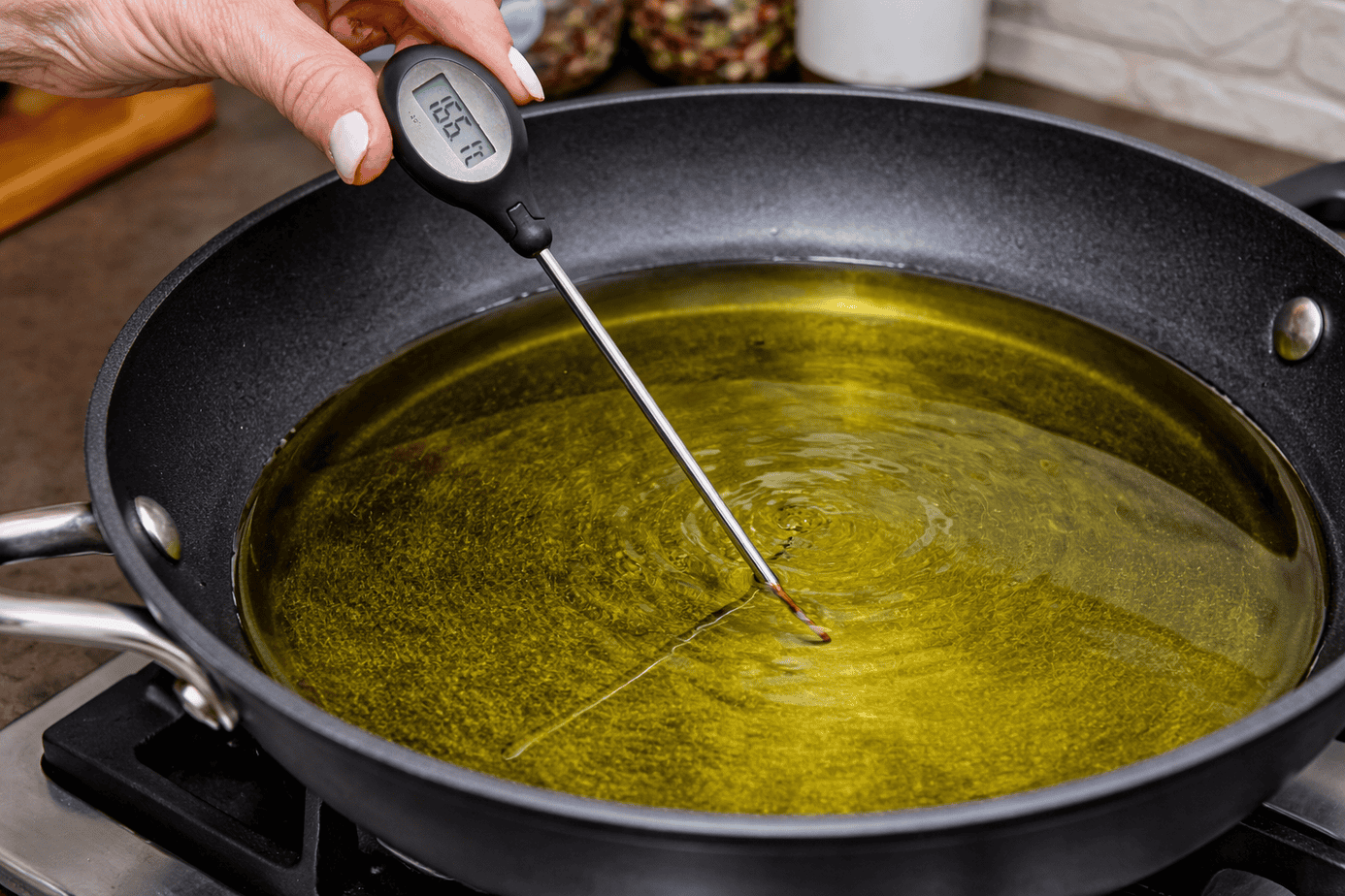 Checking-the-avocado-oil-temperature-in-the-skillet-for-frying--chicken-fried-steak Using a digital thermometer to measure frying oil temperature for gluten-free chicken-fried steak