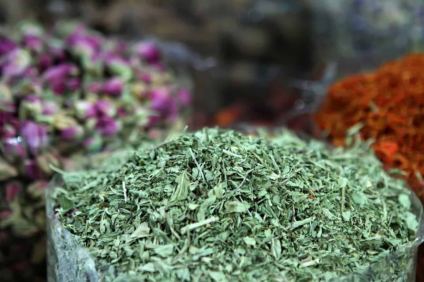 Close-up of dried Sabzi Ghormeh herbs, a traditional Persian blend of parsley, leek, and fenugreek used for flavoring soups and stews