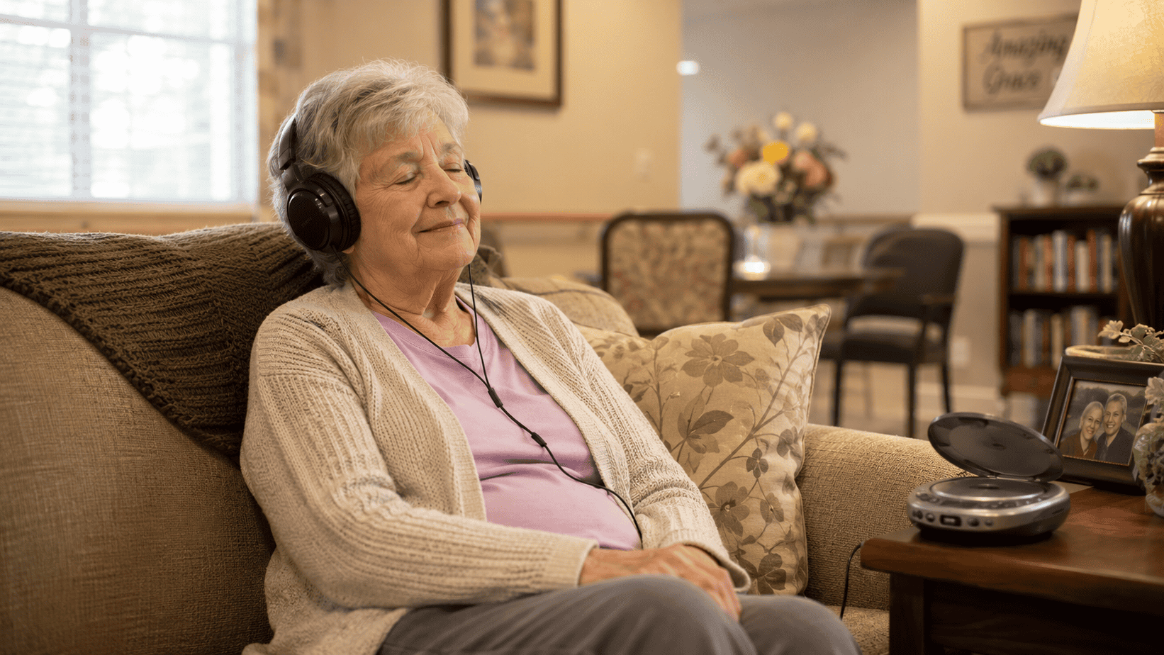 health-benefits-of-music-older-woman-listening-to-music Older woman relaxing on a sofa while listening to music through headphones, illustrating the health benefits of music