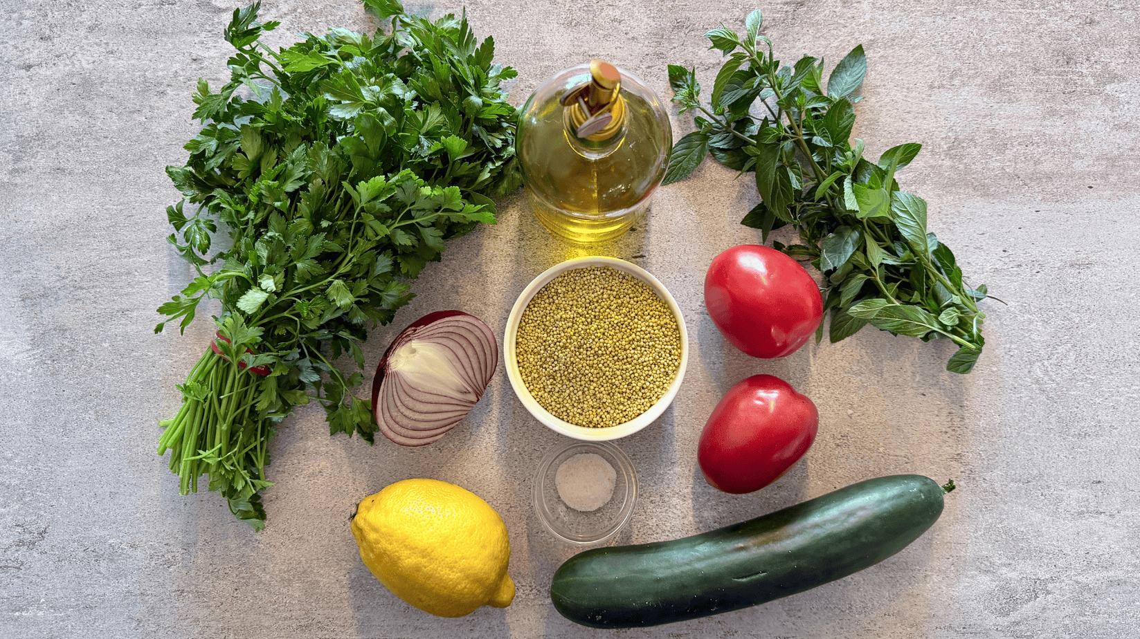 gluten-free-tabbouleh-with-millet-ingredients Ingredients for gluten-free tabbouleh with millet, parsley, mint, cucumber, tomatoes, red onion, lemon, olive oil, and sea salt
