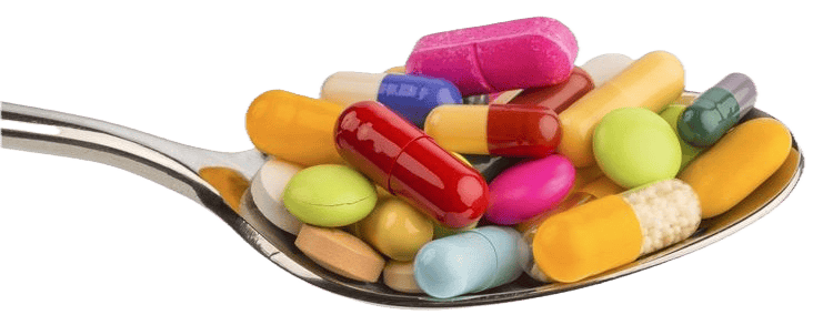 Spoon overflowing with colorful pills and capsules