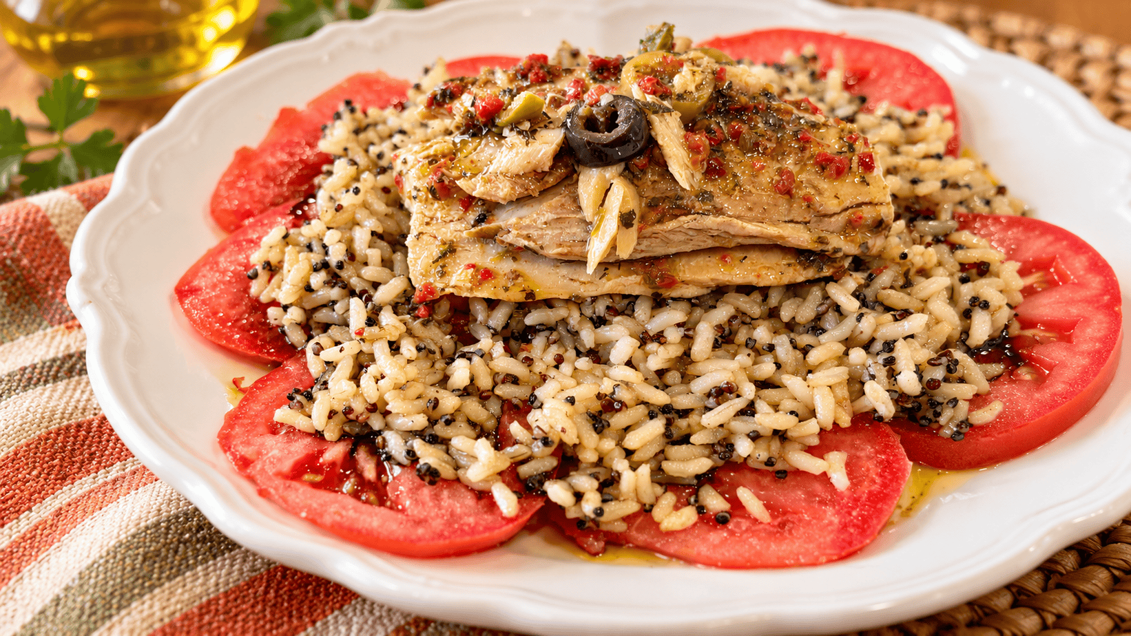 mediterranean-mackerel-plate-tomatoes-grains Mediterranean mackerel plate with olives and herbs over warm brown rice, quinoa, and fresh tomato slices
